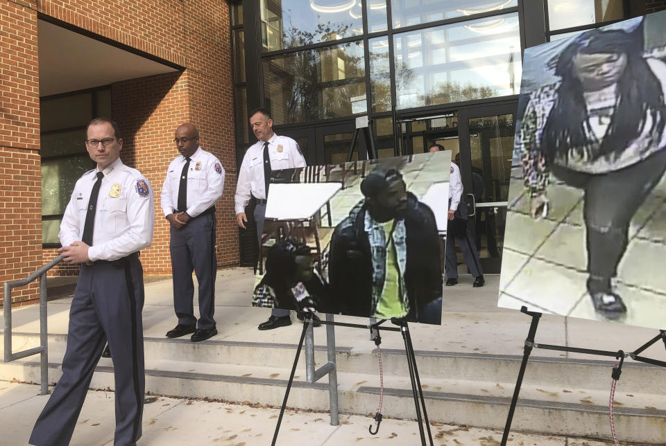 Prince George's County Police Chief Hank Stawinski addresses reporters outside a police station in Upper Marlboro, Md., Tuesday, Nov. 5, 2019, standing next to a photo of a man police suspected of killing a man and a photo of a woman who was apparently with the suspect. Police are trying to identify the suspect accused of fatally stabbing a man who was cutting in line for a chicken sandwich at a Popeyes restaurant in Maryland. (AP Photo/Michael Kunzelman)