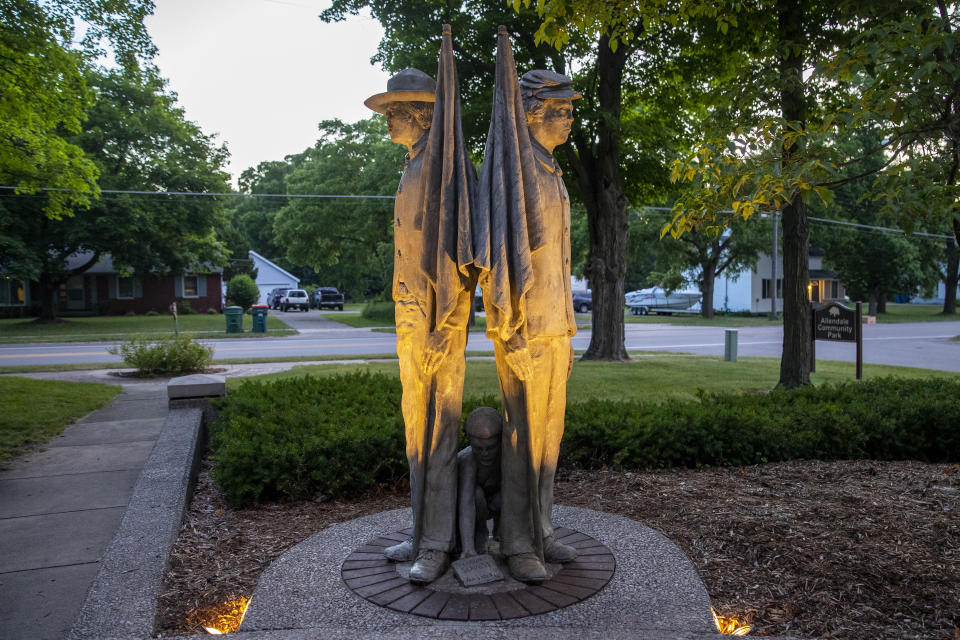 File- This June 30, 2020, file photo shows the Civil War statue at Veterans Garden of Honor in Allendale Township, Mich. A citizens committee in western Michigan has proposed removing a park statue of a Union soldier and Confederate soldier standing back to back as a slave child kneels between them. The Garden of Honor Memorial Committee presented its suggestion Monday, May 24, 2021, to the Allendale Township board which could vote June 14 on the statue’s future. (Cory Morse/The Grand Rapids Press via AP, File)