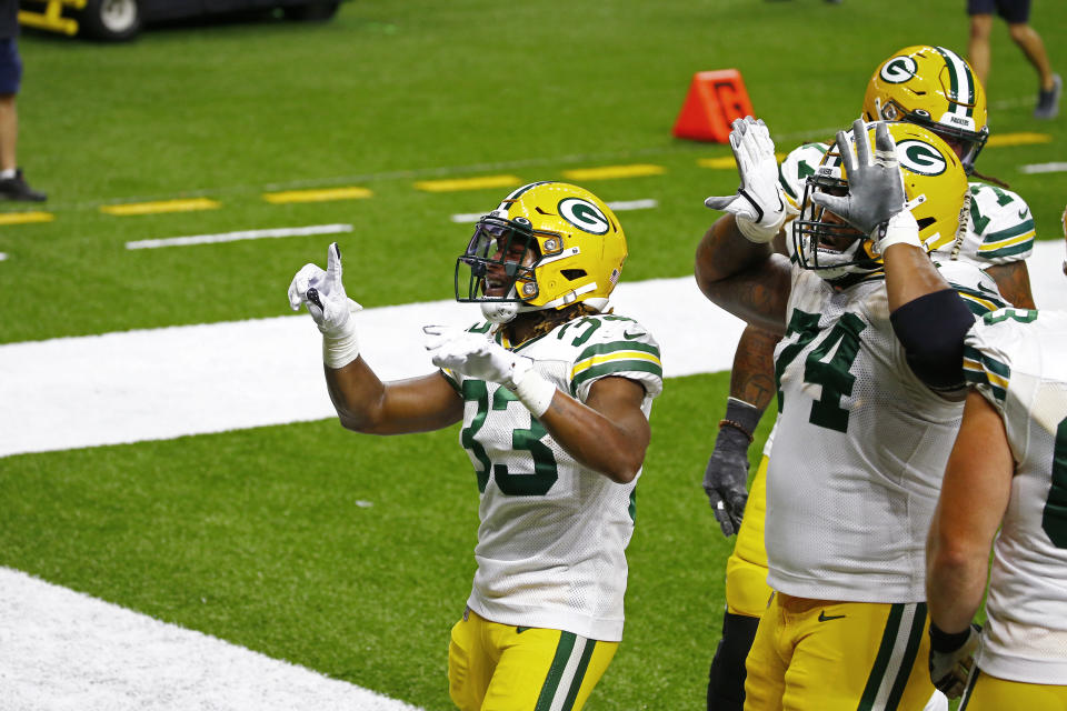 Green Bay Packers running back Aaron Jones (33) celebrates his touchdown with offensive guard Elgton Jenkins (74) in the second half of an NFL football game against the New Orleans Saints in New Orleans, Sunday, Sept. 27, 2020. (AP Photo/Butch Dill)