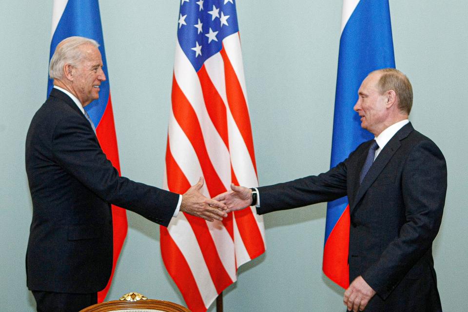 Then-Vice President Joe Biden, left, shakes hands with then-Russian Prime Minister Vladimir Putin in Moscow, Russia, on March 10, 2011.