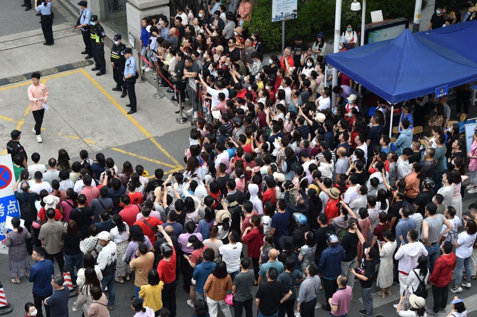 Parents wait for their children to leave the exam room at a college entrance examination site in Nanjing, Jiangsu province.