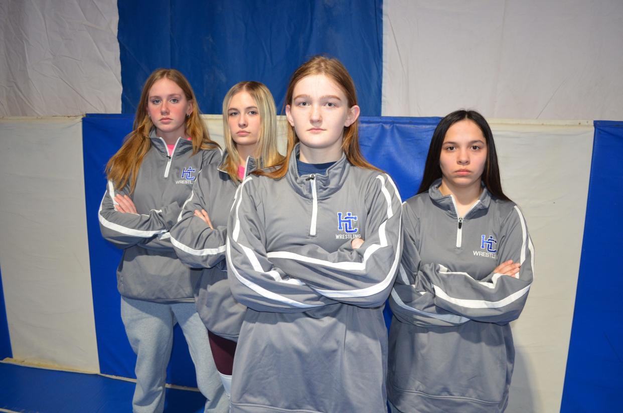 Harper Creek sophomore Alexandra Stiltner, center, placed at the state tournament last year as a freshman. She is part of the growing sport of high school girls wrestling as the Beavers have four girls on their team this year, including, pictured above, Isabella Martin, Destiny Robbins and Kayla Miller.
