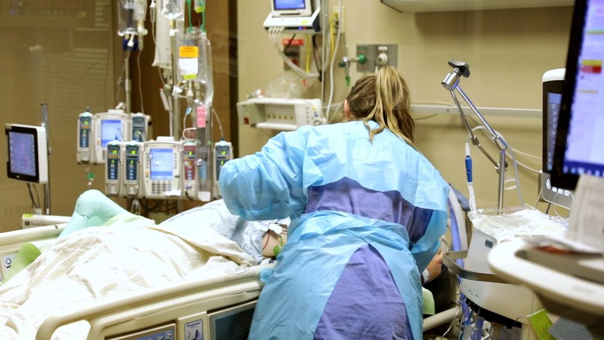 A health care professional takes care of a COVID-19 patient at Sanford Hospital.