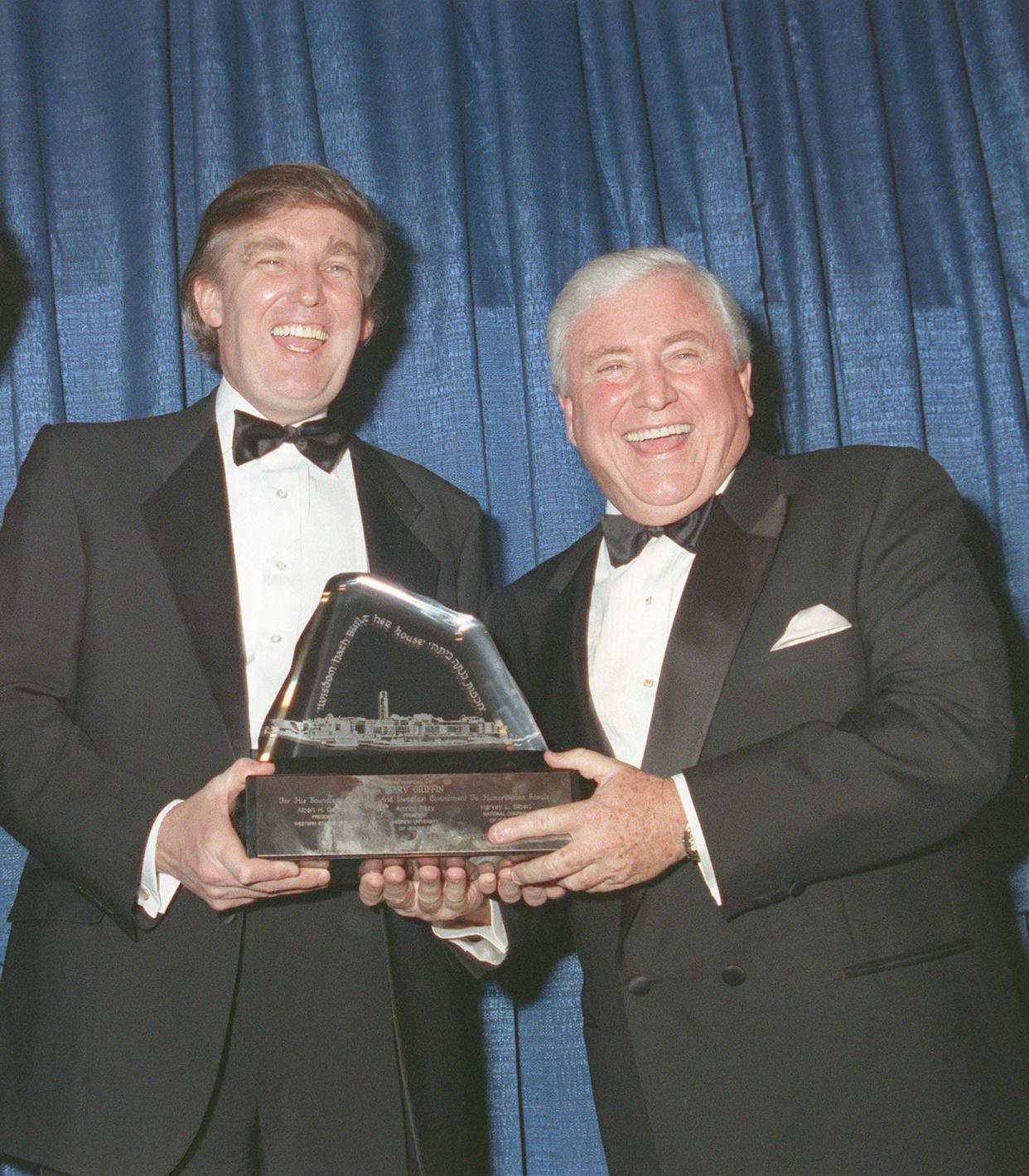 Entertainer and entrepreneur Merv Griffin, right, is presented with the 1990 Scopus Award from the American Friends of Hebrew University in Los Angeles, Ca., on Jan. 15, 1990.  Presenting the award is Donald Trump, presiding chairman for the evening.