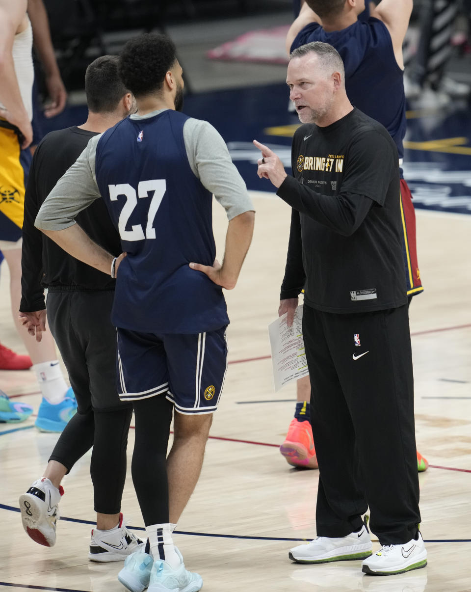 Denver Nuggets head coach Michael Malone, right, confers with guard Jamal Murray as players take part in NBA basketball practice, Wednesday, May 31, 2023, in Denver. The Warriors take on the Miami Heat in Game 1 of the NBA Finals on Thursday. (AP Photo/David Zalubowski)