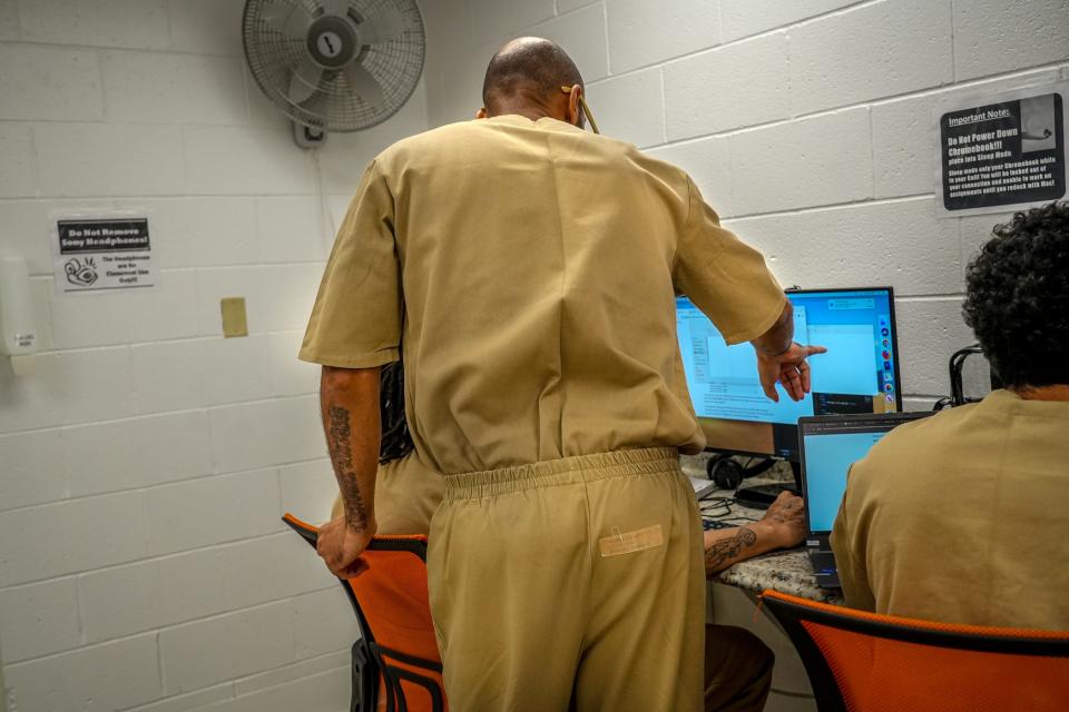 Students collaborate on a problem in The Last Mile program at the ACI. A state Department of Corrections report says that of the roughly 2,300 people released from prison in 2019, 45% returned within three years. The report cites studies showing that former inmates who stay out of prison for three years are much less likely to return.