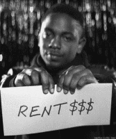 Man holding a sign that says "RENT $$$" with a serious expression