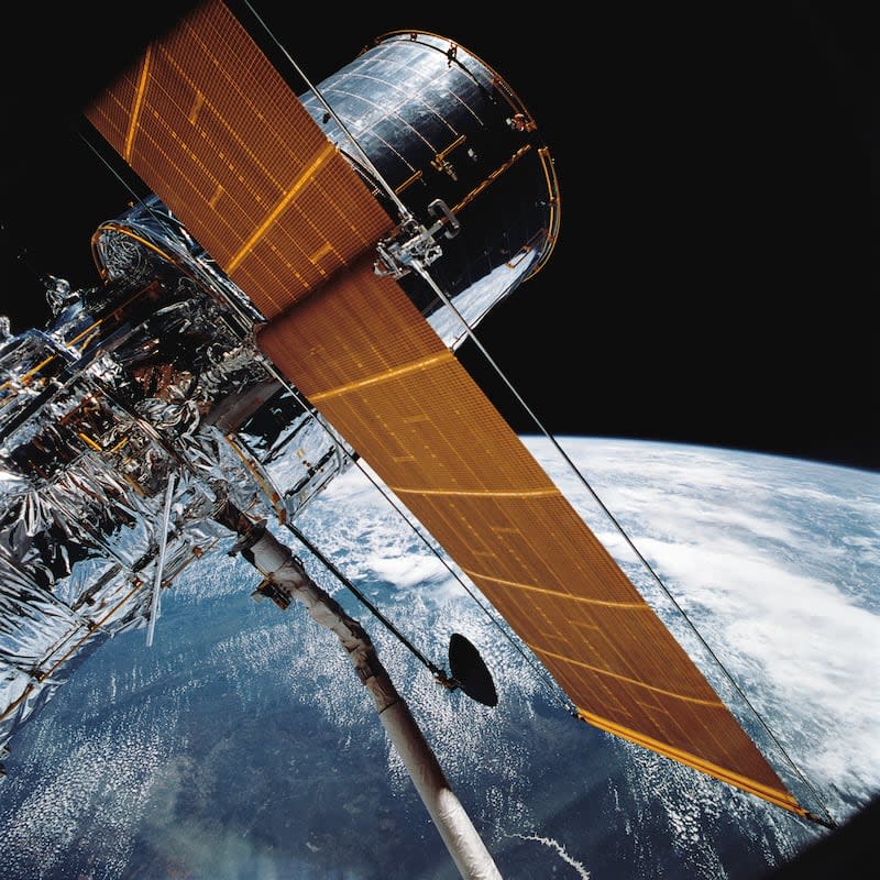 In this April 25, 1990, photograph provided by NASA, most of the giant Hubble Space Telescope can be seen as it is suspended in space by Discovery's Remote Manipulator System following the deployment of part of its solar panels and antennae. This was among the first photos NASA released on April 30 from the five-day STS-31 mission. The Hubble Space Telescope, one of NASA'S crowning glories, is marking its 34th anniversary. | NASA via Associated Press