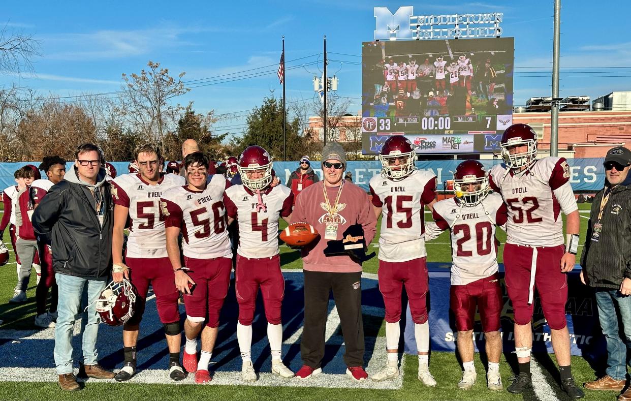 Captains of the James I. O'Neill football team receive a final four plaque after falling to Fonda-Fultonville in the Class C state semifinal on Nov. 25, 2023.