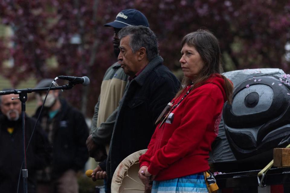 Lummi Tribal members Siam’el wit, right, and Doug James joined by fly angler Gian Lawrence, offer prayer and song to bless the totem pole at The Snake River to Salish Sea Spirit of the Waters totem pole journey launch Tuesday, May 3, 2022, at Bellingham Unitarian Fellowship in Bellingham, Wash.