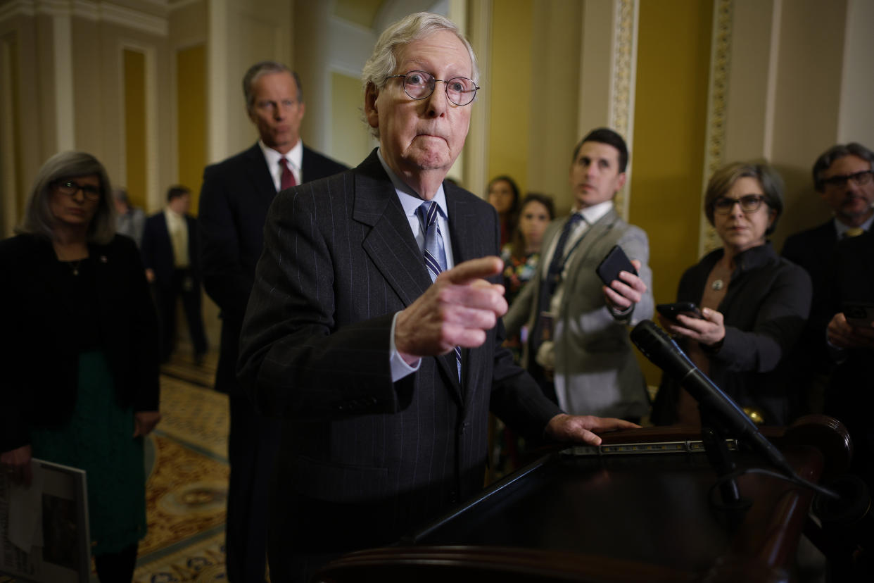 Sen. Mitch McConnell talks to reporters.