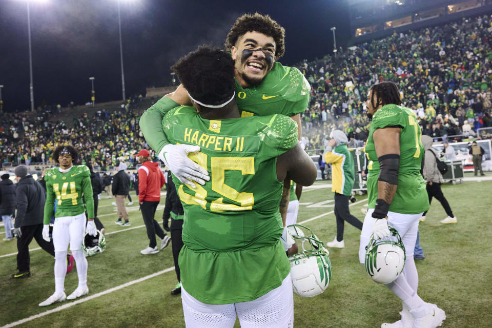 Nov. 19, 2022; Eugene, Oregon; Oregon Ducks offensive lineman Marcus Harper II (55) celebrates with Oregon Ducks defensive back Bennett Williams (4) after a game against the Utah Utes at Autzen Stadium. The Ducks won the game 20-17. Troy Wayrynen-USA TODAY Sports