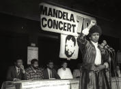 Winnie Mandela raises her fist in a black power salute after announcing that a massive pop concert will be held to mark the 70th birthday of her husband, jailed black nationalist leader Nelson Mandela on July 17, 1988. (Wendy Schwegmann / Reuters)