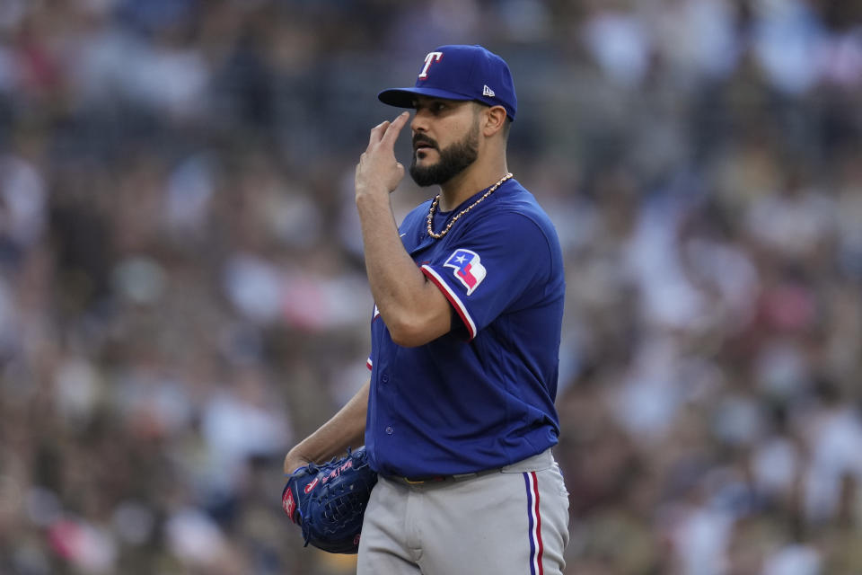 Texas Rangers starting pitcher Martin Perez gestures after being called for a balk during the fifth inning of a baseball game against the San Diego Padres, Saturday, July 29, 2023, in San Diego. (AP Photo/Gregory Bull)