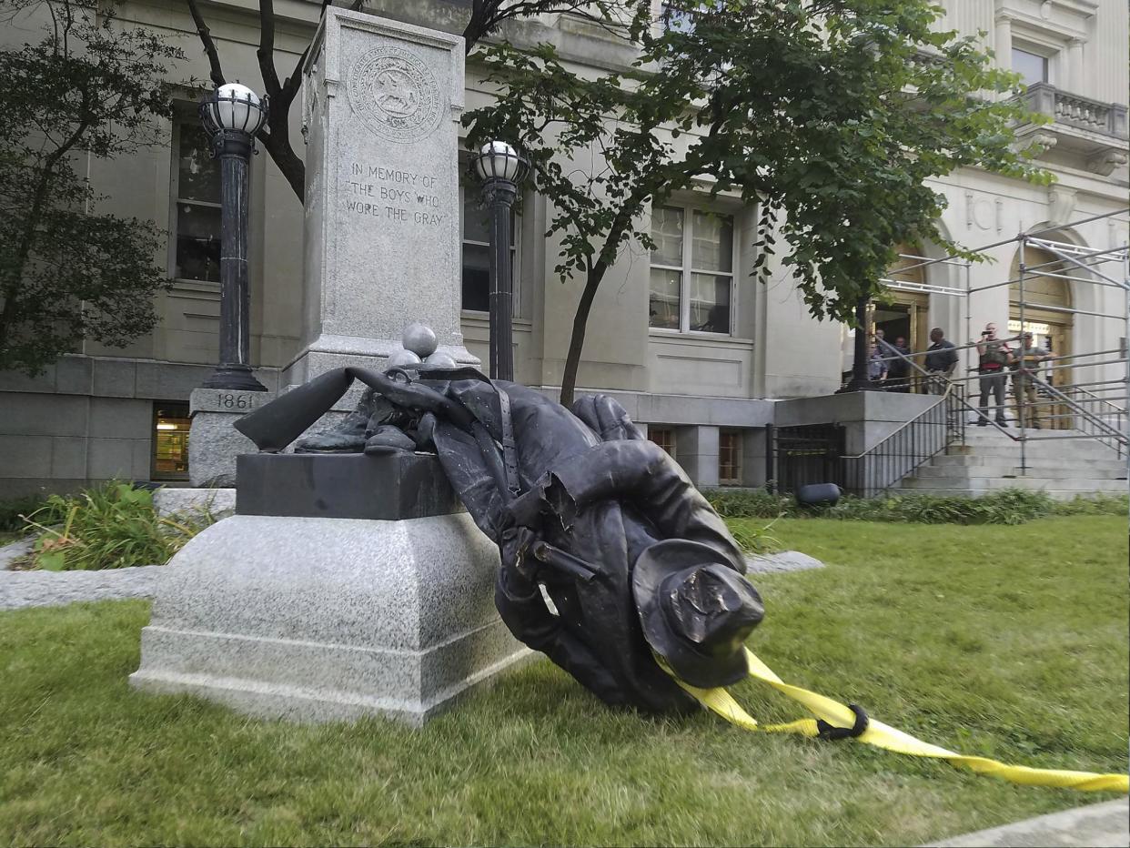 A toppled Confederate statue lies on the ground on 14 August 2017 in Durham, North Carolina where activists used a rope to pull it down after the violence in Charlottesville, Virginia: AP