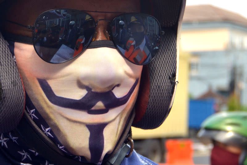 A motorcyclist wears a protective face mask during large-scale social restrictions to prevent the spread of coronavirus disease (COVID-19)