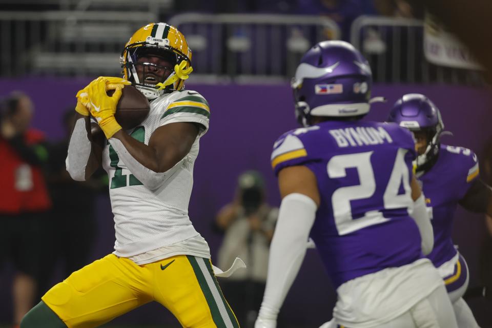 Green Bay Packers' Jayden Reed catches a touchdown pass in front of Minnesota Vikings' Camryn Bynum during the first half of an NFL football game Sunday, Dec. 31, 2023, in Minneapolis. (AP Photo/Bruce Kluckhohn)