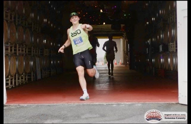 Sam Norton points the way while running in the Santa Rosa Marathon last month.