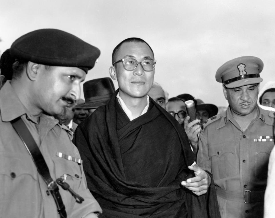 FILE - In this April 18, 1959, file photo, Tibetan spiritual leader the Dalai Lama, center, arrives at Tezpur, Assam in India. Tibetan activists put up posters and hoisted a Tibetan flag in India's capital New Delhi on Sunday, March 10, 2019, to mark the 60th anniversary of 1959 uprising against Chinese rule. (AP Photo, File)