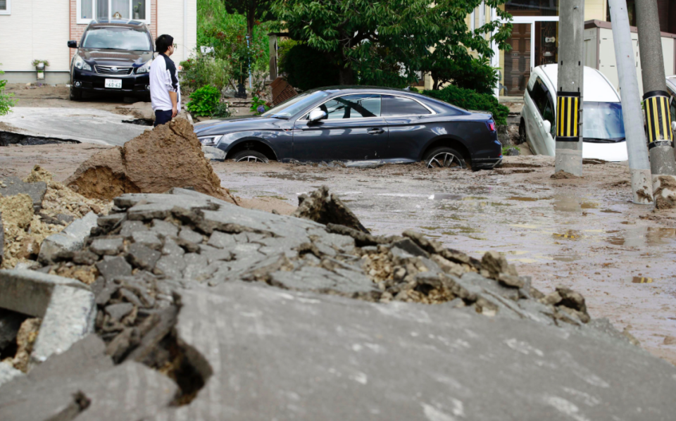 <em>Cars were stuck in mud-covered roads following the quake (AP)</em>