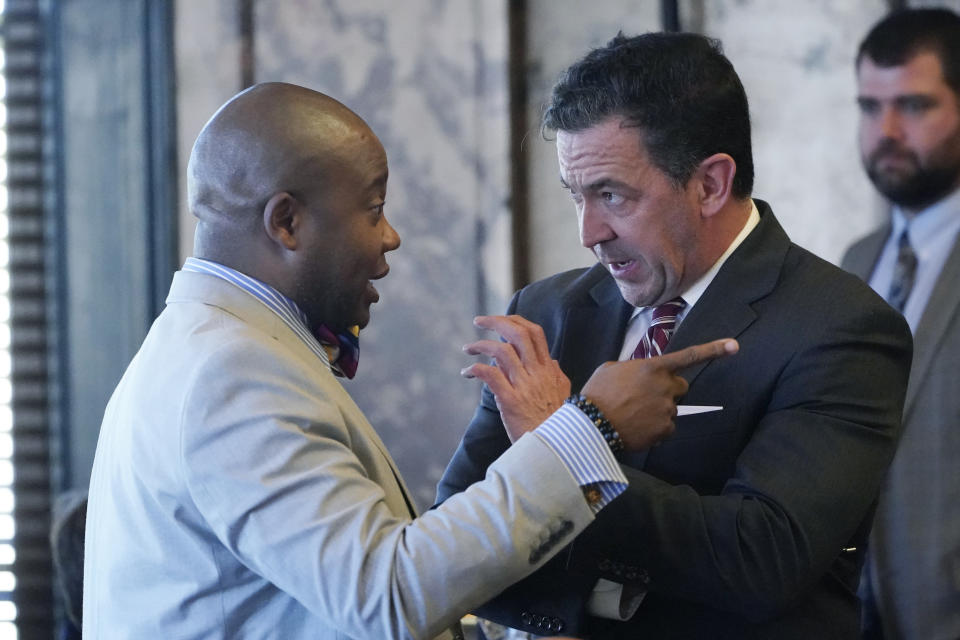 Sen. Derrick Simmons, D-Greenville, left, and Sen. Chris McDaniel, R-Ellisville, confer after a bill that would reduce the state income tax over four years, beginning in 2023, was passed, Sunday, March 27, 2022 at the Mississippi Capitol in Jackson. (AP Photo/Rogelio V. Solis)