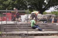 Workers dig up the remains of Confederate Gen. Nathan Bedford Forrest and his wife to move the bodies from Health Sciences Park June 4, 2021, in Memphis, Tenn. With the approval of relatives, the remains will be moved to the National Confederate Museum in Columbia, Tenn. (AP Photo/Karen Pulfer Focht)