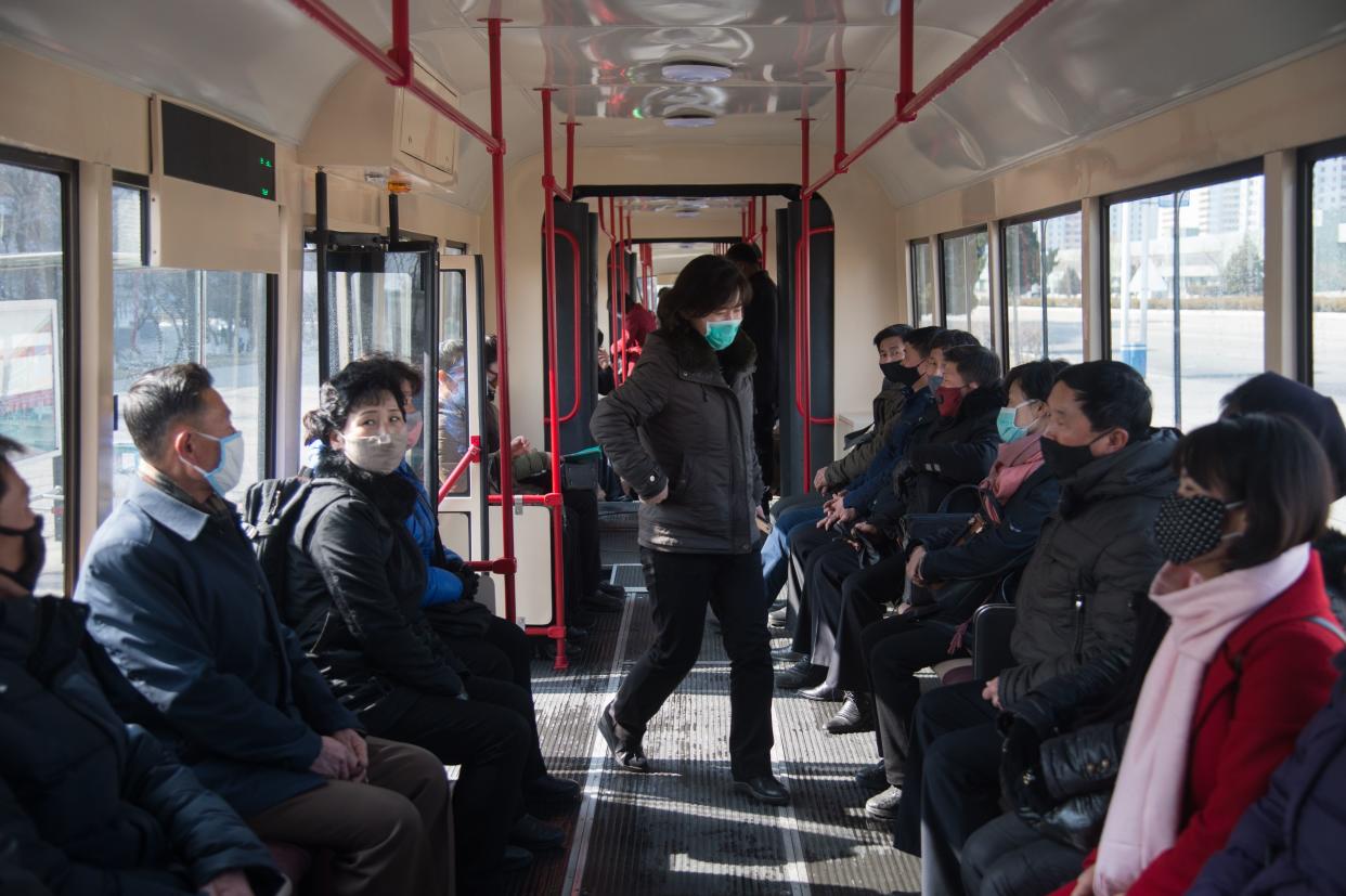 Commuters wearing face masks ride a tramcar in Pyongyang on February 26, 2020. - The novel coronavirus has killed over 2,700 people and infected more than 80,000 in 34 countries, although the vast majority of cases remain in China, according to the World Health Organization (WHO). (Photo by KIM Won Jin / AFP) (Photo by KIM WON JIN/AFP via Getty Images)