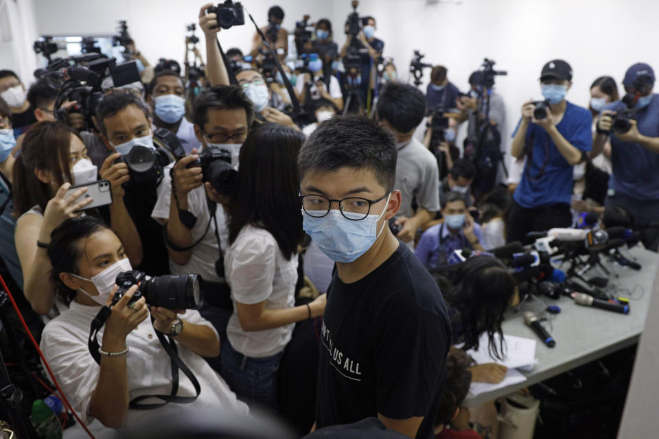 Hong Kong pro-democracy activist Joshua Wong, center, attends a press conference in Hong Kong, Friday, July 31, 2020. At least 12 Hong Kong pro-democracy nominees including prominent activist Joshua Wong were disqualified for September legislative elections, with authorities saying Thursday they failed to uphold the city's mini-constitution and pledge allegiance to Hong Kong and Beijing. (AP Photo/Kin Cheung)