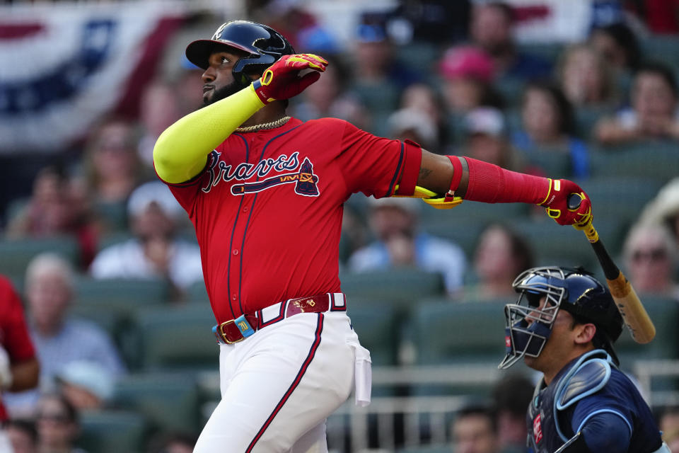 Atlanta Braves designated hitter Marcell Ozuna (20) and Tampa Bay Rays catcher Alex Jackson (28) watch a three-run home run in the first inning of a baseball game Friday, June 14, 2024, in Atlanta. (AP Photo/John Bazemore)