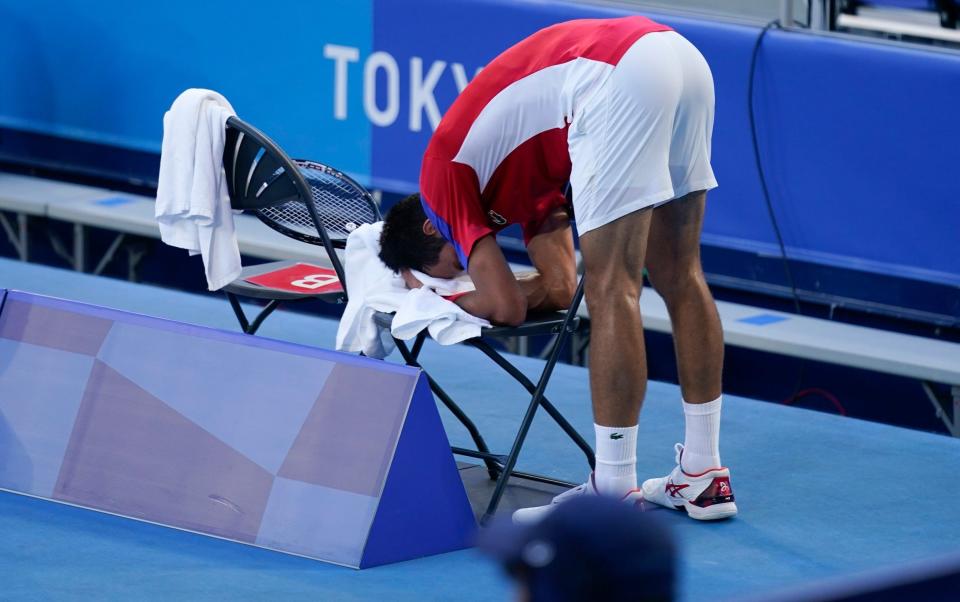  Novak Djokovic, of Serbia, reacts during the bronze medal match of the tennis competition against Pablo Carreno Busta, of Spain, at the 2020 Summer Olympics, Saturday, July 31, 2021, in Tokyo, Japan - AP