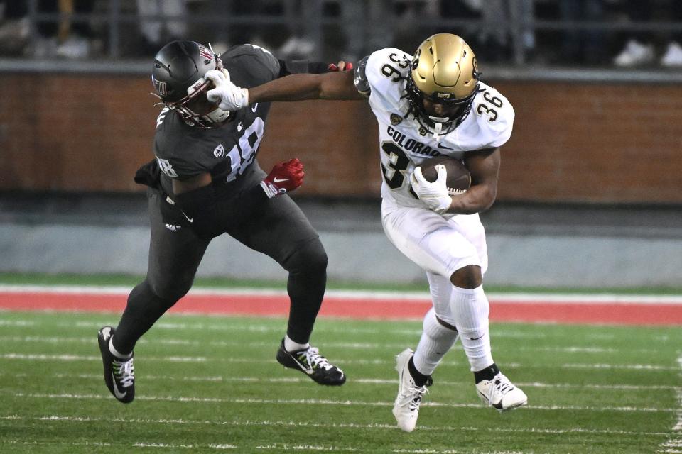 Colorado running back Sy'veon Wilkerson (36) stiff-arms Washington State linebacker Taariq Al-Uqdah (18).