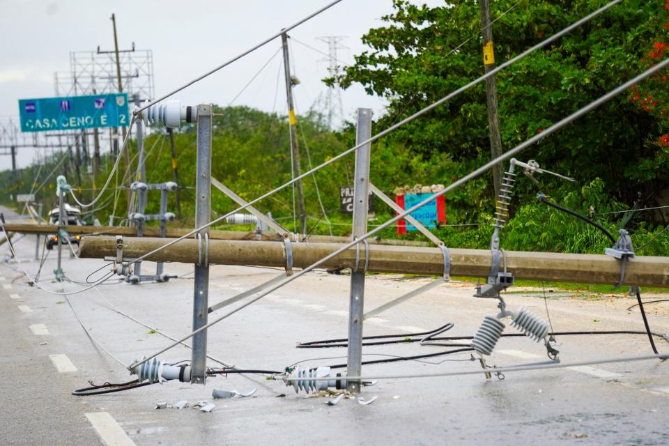 Power lines lie on a road in Tulum, Mexico after Hurricane Beryl on Friday (AFP via Getty Images)