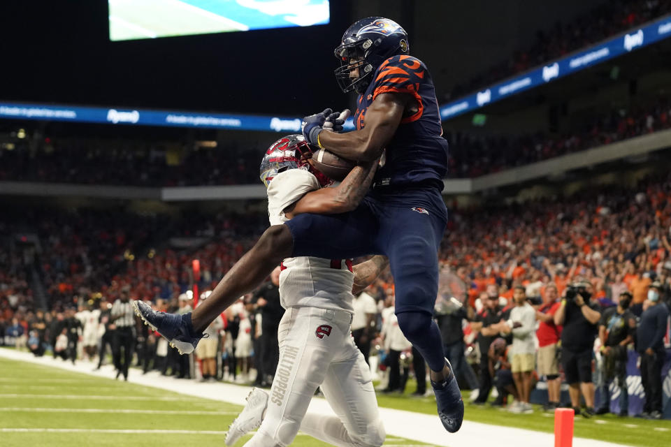 UTSA wide receiver De'Corian Clark, right, catches a pass over Western Kentucky defensive back Miguel Edwards, left, for a touchdown during the second half of an NCAA college football game in the Conference USA Championship, Friday, Dec. 3, 2021, in San Antonio. (AP Photo/Eric Gay)