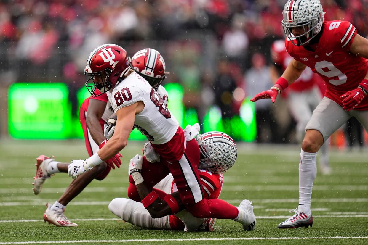 Nov 12, 2022; Columbus, Ohio, USA;  Ohio State Buckeyes safety Josh Proctor (41) tackles Indiana Hoosiers wide receiver Connor Delp (80) on a kickoff during the first half of the NCAA football game at Ohio Stadium. Mandatory Credit: Adam Cairns-The Columbus Dispatch