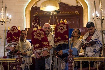 <span class="caption">Worshippers celebrate the Jewish new year, Rosh Hashana, at Shaare Rason Synagogue in Mumbai, India.</span> <span class="attribution"><a class="link " href="https://www.gettyimages.com/detail/news-photo/the-jewish-community-people-offer-prayers-as-they-celebrate-news-photo/1172725974?phrase=indian%20jewish&adppopup=true" rel="nofollow noopener" target="_blank" data-ylk="slk:Pratik Chorge/Hindustan Times via Getty Images;elm:context_link;itc:0;sec:content-canvas">Pratik Chorge/Hindustan Times via Getty Images</a></span>