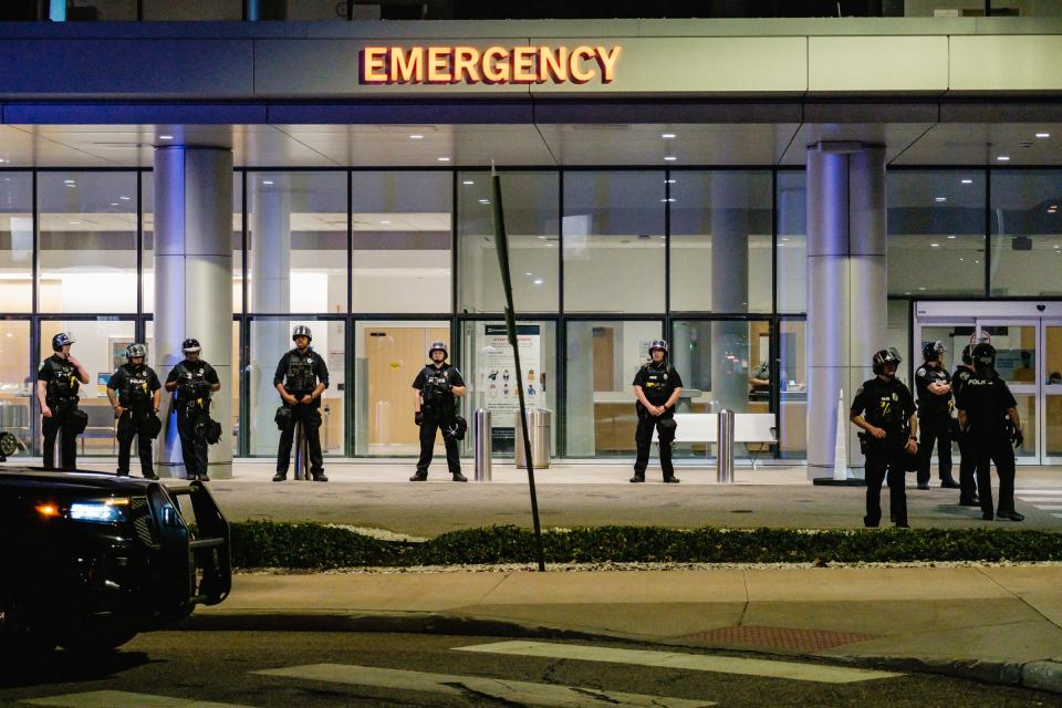 Akron police in riot gear guard the emergency entrance to Cleveland Clinic Akron General during a lockdown late Wednesday night.