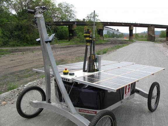 The modified Zoe rover, with the upper portion of the drill mechanism jutting above the solar array, during testing on a former industrial site in Pittsburgh.