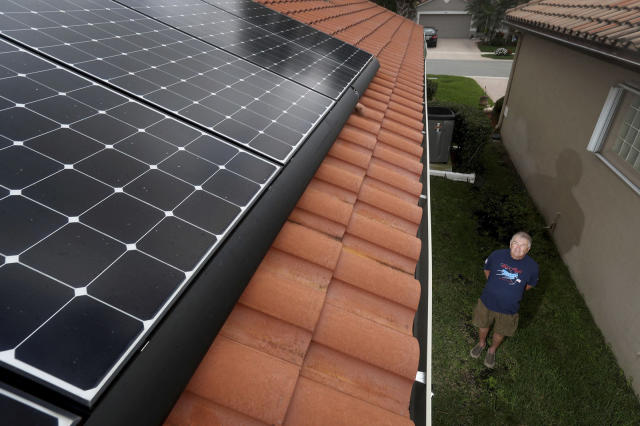 Boynton Beach resident Fred Closter shows off his $40,000 rooftop solar power system, which includes $24,000 in solar panels and two $8,000 Tesla storage batteries that enable Closter and his wife to live almost completely free of FPLs grid. Congress and the Biden Administration last week made it easier for other Floridians to achieve the same goal by increasing the 30% federal tax credit for solar systems through 2032. (Susan Stocker/Sun Sentinel/Tribune News Service via Getty Images)