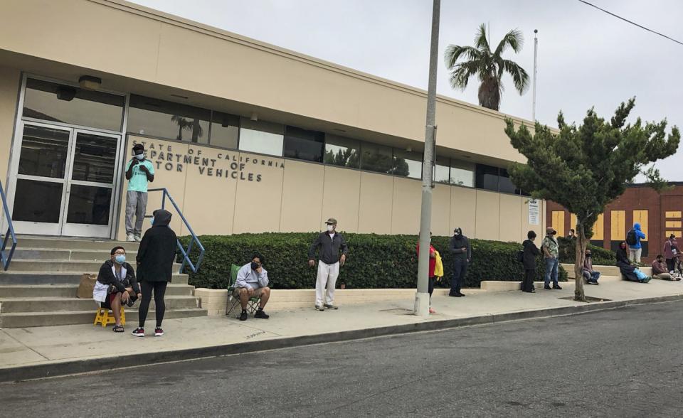 People wait in line outside the DMV field office in Hollywood.