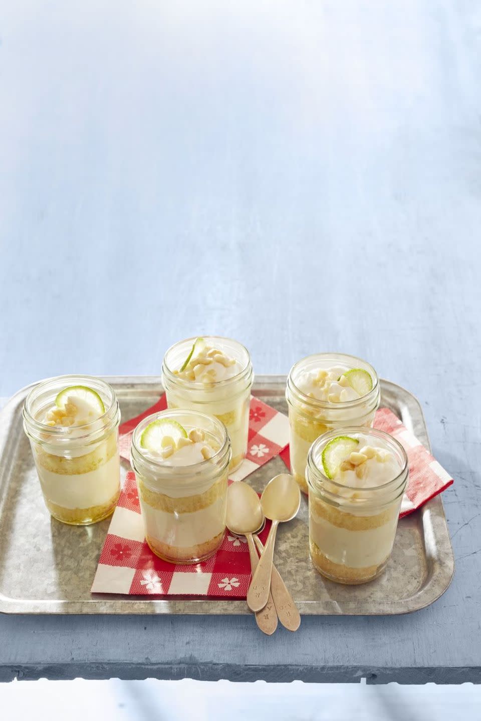 key lime cakes in a jar on metal tray with red napkins