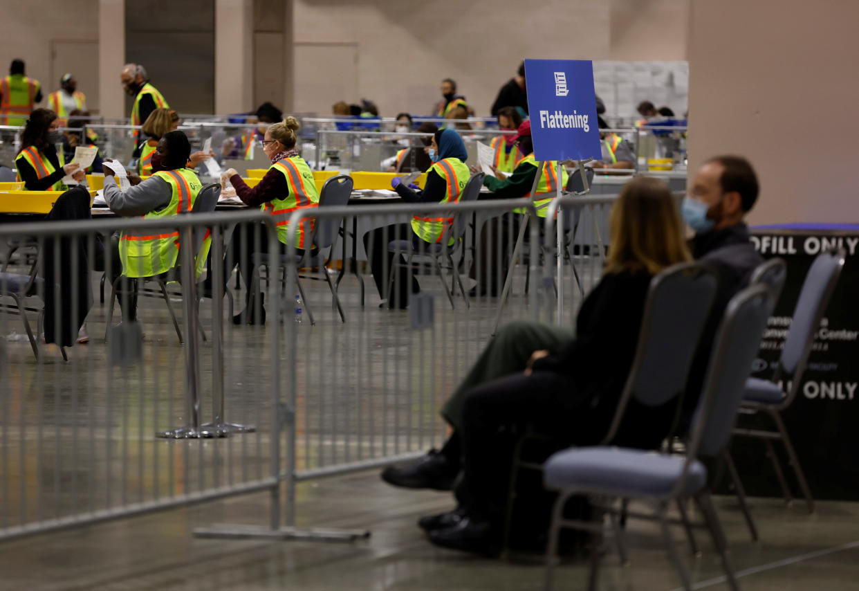 Poll watchers observe as votes are counted at the Pennsylvania Convention Center on Election Day.