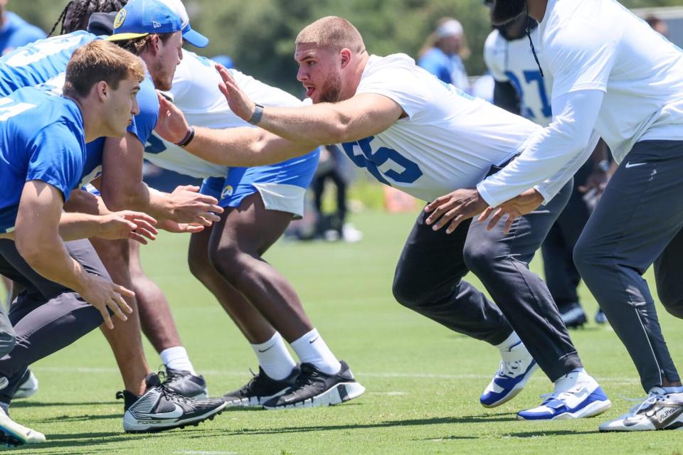 Rams defensive lineman Braden Fiske (55) gets his hands up during a line drill.