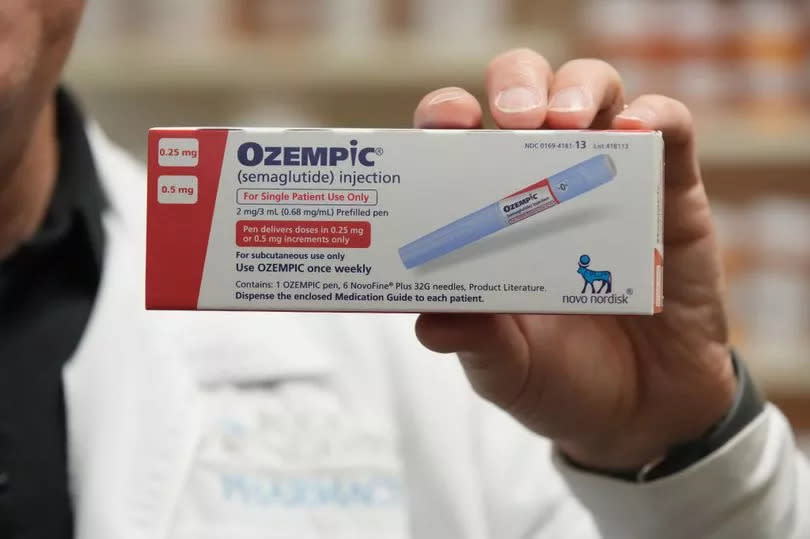 A pharmacist holds a box of Novo Nordisk A/S Ozempic brand semaglutide medication
