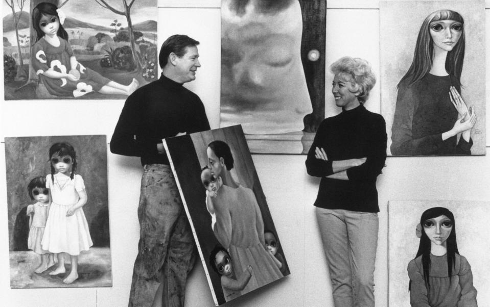 Margaret Keane with her husband Walter, who is holding a painting, thought at the time to be by him, titled 'We Will Overcome' - Bettmann