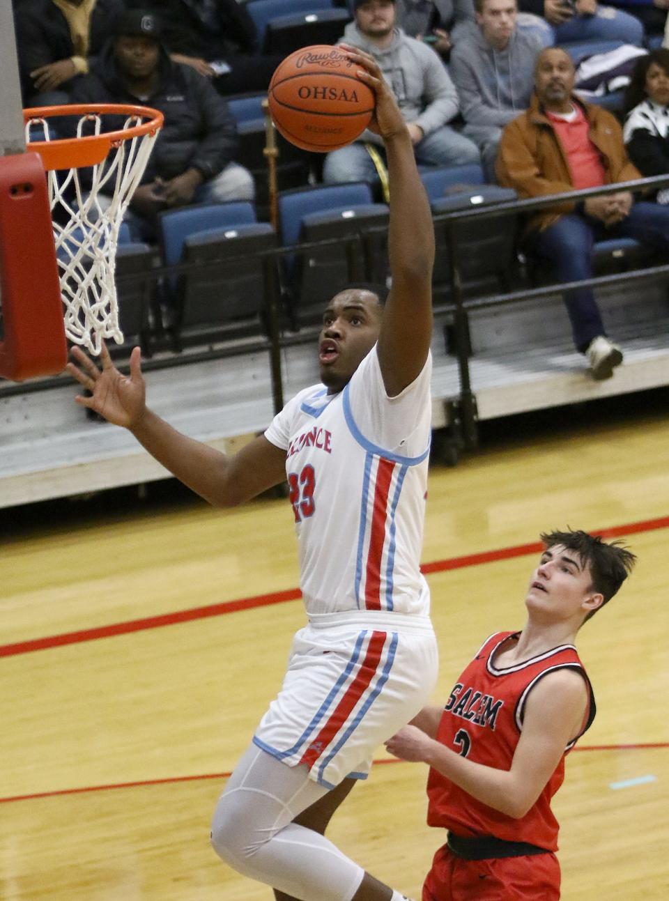 Alliance's Diego Allen, left, scores a layup against Salem's Caden Swiger, during an Eastern Buckeye Conference game at Alliance High School Friday, December 2, 2022.