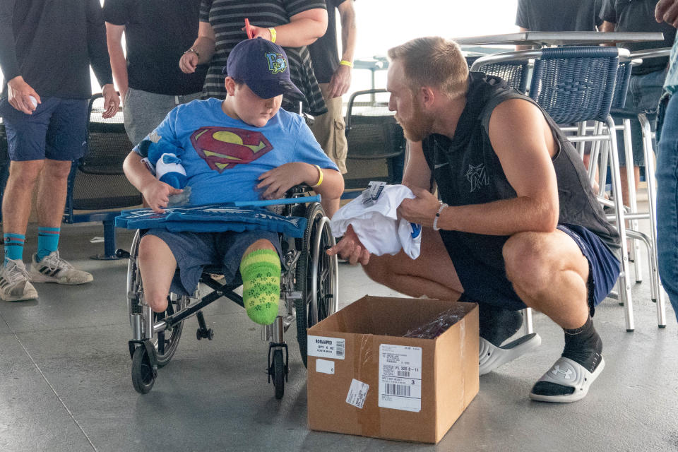 Blue Wahoos pitcher Andrew McInvale visits with Gunnar Chester on Aug. 13 prior to Blue Wahoos game that night.