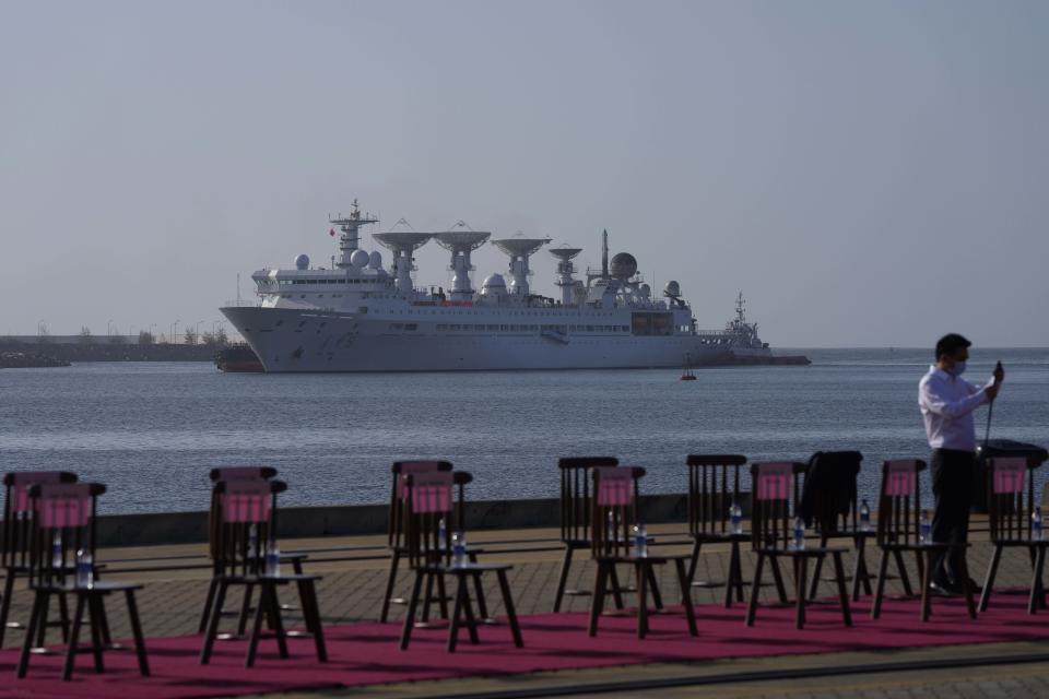 A Chinese expatriate in Hambantota International Port prepares to welcome Chinese research ship Yuan Wang 5 in Hambantota, Sri Lanka, Tuesday, Aug. 16, 2022. The ship was originally set to arrive Aug. 11 but the port call was deferred due to apparent security concerns raised by India. (AP Photo/Eranga Jayawardena)