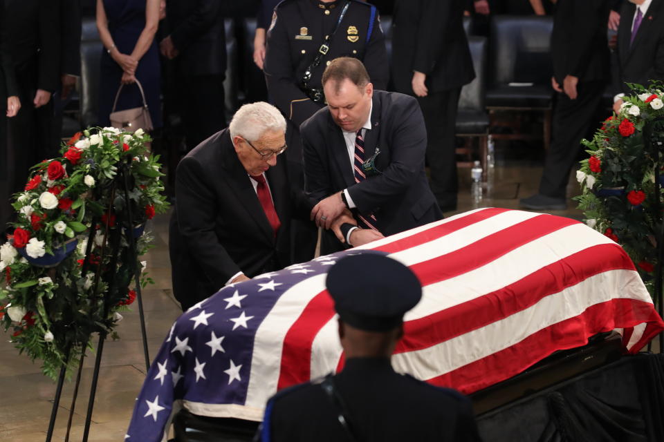 Former U.S. Secretary of State Henry Kissinger (left) honors the late senator.