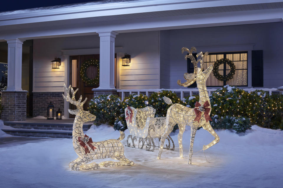 This image provided by The Home Depot shows their Polar Wishes collection including lighted white deer and sleigh figures. A winter white theme is one of this season's most popular; it appeals to modern, naturalist and traditional home decorators. (The Home Depot via AP)
