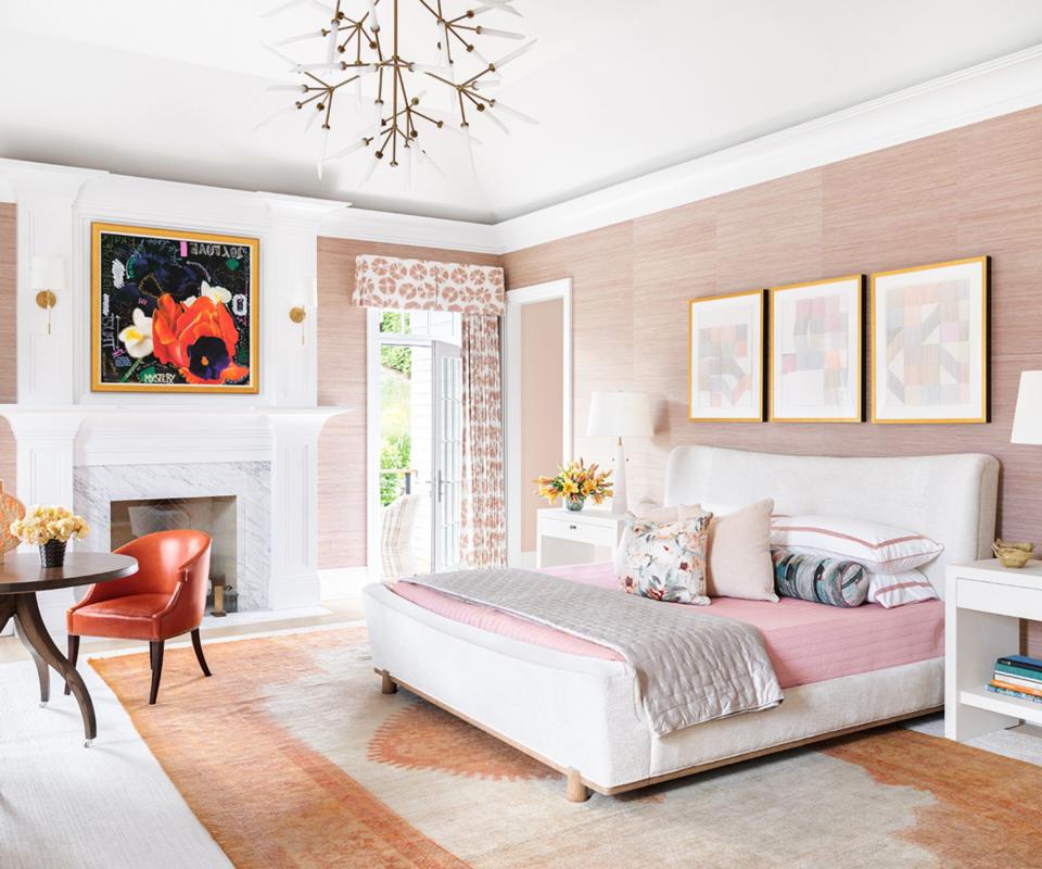 bedroom with pink wallpaper and botanical prints